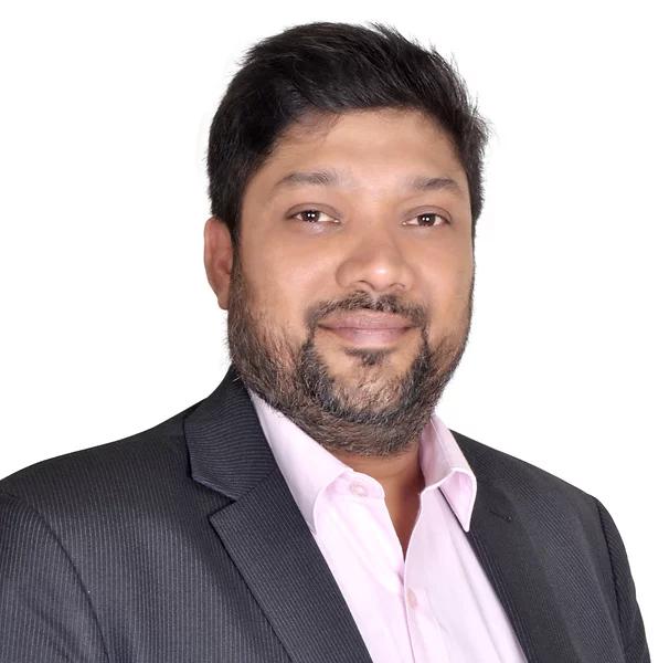 Photograph of Rahul Agarwal, smiling and looking forward, wearing a gray blazer and light pink business shirt