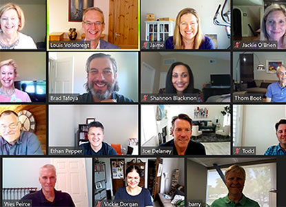 Screenshot photo of online video call showing all attendees looking forward and smiling.