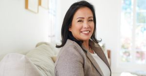 A Photo of Registered Life Planner, Cristina Livadary sitting on a sofa.