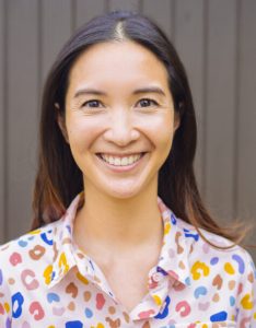 Woman in a colorful top with dark brown hair.